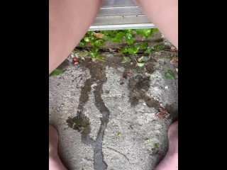 Girl peeing in doorway onto steps