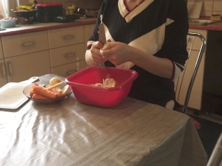 Sexy dressed wife preparing food in the kitchen