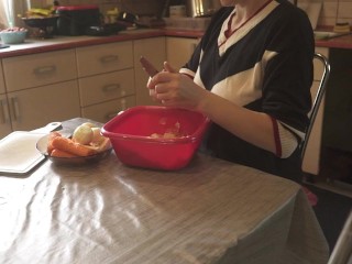 Sexy dressed wife preparing food in the kitchen