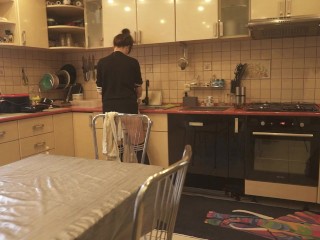 Sexy dressed wife preparing food in the kitchen