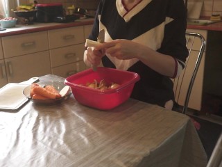 Sexy dressed wife preparing food in the kitchen