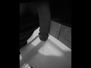 Taking a quick piss on the shower floor, with my semi hard cock