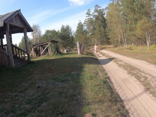 Nude girl walking in the village
