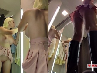 Upskirt view on Blonde with big boobs tries on transparent clothes. Video from public locker room