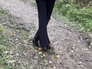 girl in high-heeled boots wants to go to home, but there is dirty slippery slide on the way