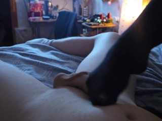 Girlfriend gives stocking footjob while watching tv