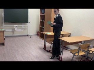 The teacher is preparing for the lesson and feels that her shoes are rubbing on her