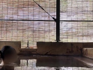 Japanese girl bathing in a mixed outdoor bath at a hot spring inn