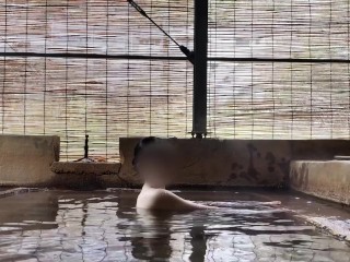 Japanese girl bathing in a mixed outdoor bath at a hot spring inn