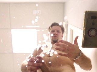 Handsome guy cumming on a transparent table (look from below)