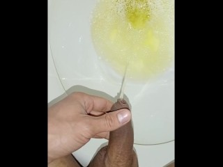 Desperate young man pissing, morning erection, close-up