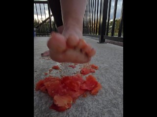 Squishing a juicy tomato with my bare feet, the juices squirted everywhere!