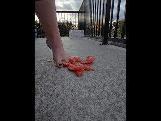 Squishing a juicy tomato with my bare feet, the juices squirted everywhere!