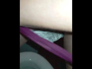 Bushy pussy girl peeing in the toilet with a sanitary pad in her panties