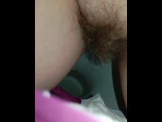 Bushy pussy girl peeing in the toilet with a sanitary pad in her panties