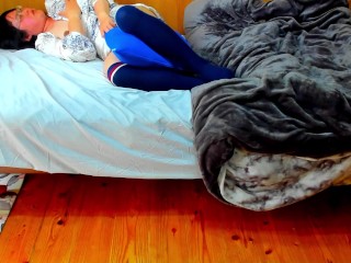 A busty Japanese woman masturbates with a beanbag cushion between her legs.