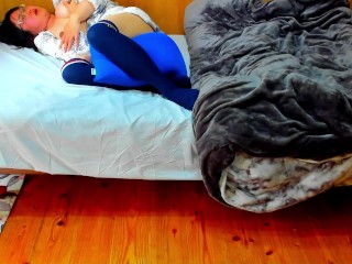 A busty Japanese woman masturbates with a beanbag cushion between her legs.