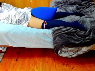 A busty Japanese woman masturbates with a beanbag cushion between her legs.