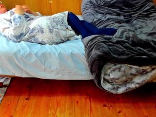 A busty Japanese woman masturbates with a beanbag cushion between her legs.