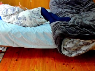 A busty Japanese woman masturbates with a beanbag cushion between her legs.