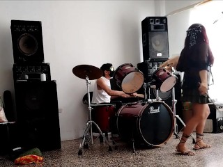 They play the drums for her - she dances, stripping and showing her ass