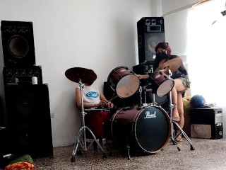 They play the drums for her - she dances, stripping and showing her ass