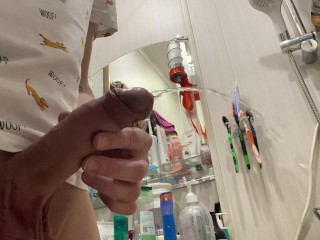 Morning pissing of uncircumcised penis in the bathroom