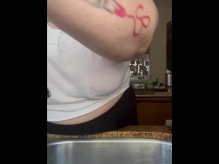 Housewife with no bra doing dishes