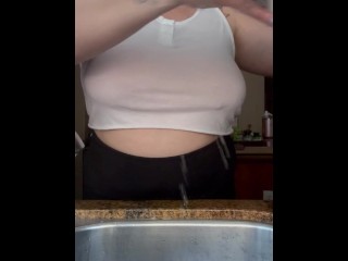 Housewife with no bra doing dishes
