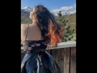 Young student shows off her charms against the backdrop of mountains