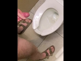 Hung guy freeballing at casino, big dick got hard so took off pants in bathroom and squirted a load.