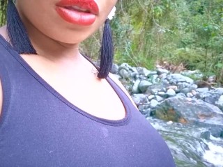 Ebony milf with red wig gets conscious next to a river