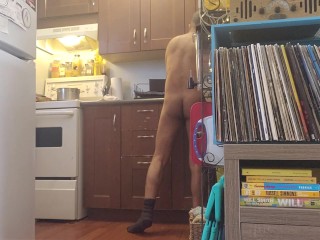 Bachelor undress while doing dishes.
