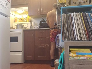 Bachelor undress while doing dishes.