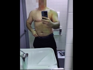 Sexy stud shows off his big soft cock in a public restroom