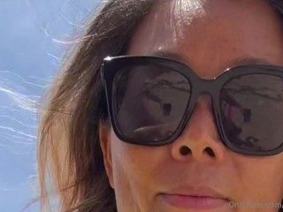 23 asian wife gives handjob on the beach in fishnet dress