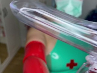 Speculum in my hands wrapped in red Latex gloves