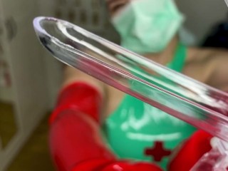 Speculum in my hands wrapped in red Latex gloves