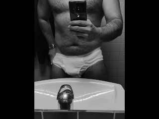 Hot guy in tighty whities pulls out his big soft cock in the office restroom