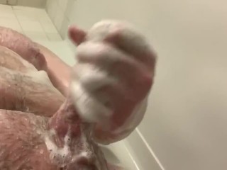 Husky guy rubs his cock in the shower 