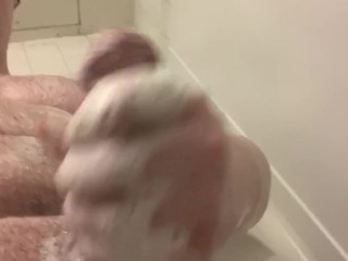 Husky guy rubs his cock in the shower 