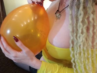 Pop ballon with red long nails