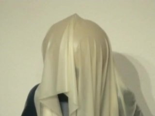 Girl With Transparent Latex Ballhood And Rubber Sheet Makes Breath Play