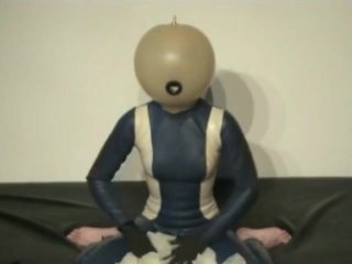 Girl With Transparent Latex Ballhood And Rubber Sheet Makes Breath Play