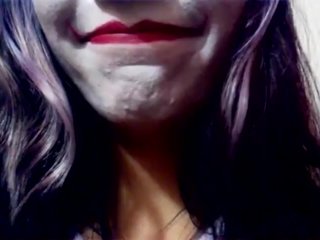 Harley Quinn playing with her mouth