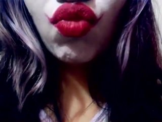 Harley Quinn playing with her mouth