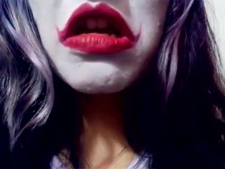 Harley Quinn playing with her mouth