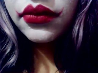 Harley Quinn playing with her mouth