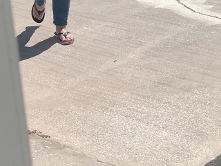 Female friend feet in flip flops coming to see me in public, in motion view