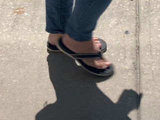 Female friend feet in flip flops coming to see me in public, in motion view